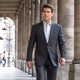Tom Cruise in a suit waiting through columns.